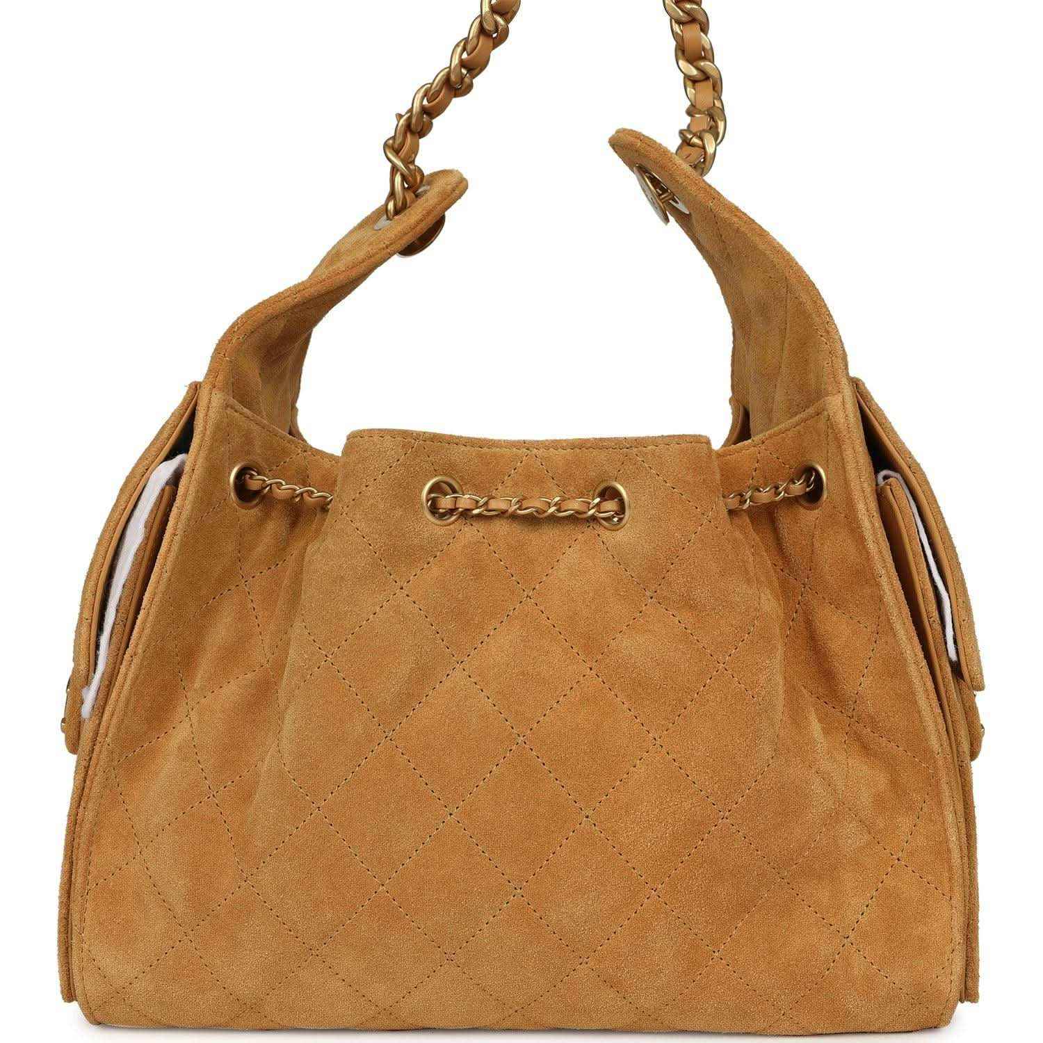Tan suede hobo bag with antique gold chain handles and drawstring cord closures