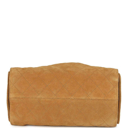 Tan quilted suede hobo bag with rounded back and stitched flap panel