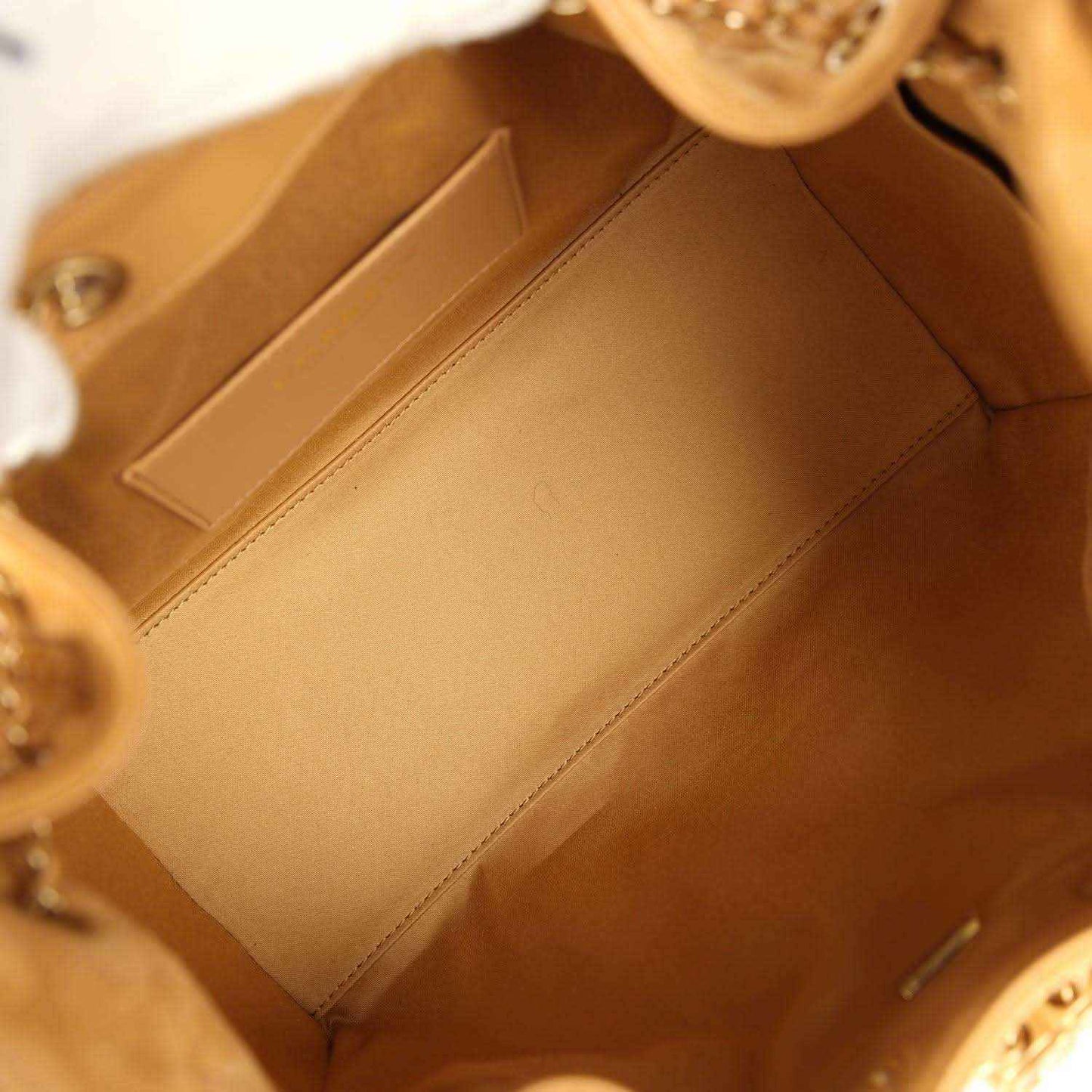 Tan suede hobo bag interior with stitched side panels and inner pocket