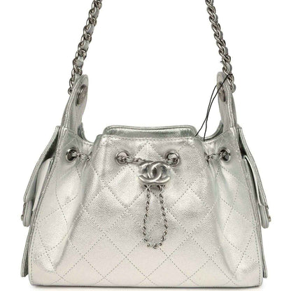 Metallic silver mini hobo bag with quilted caviar texture, chain strap, logo clasp