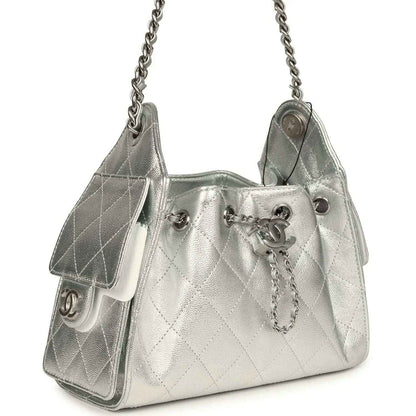 Metallic silver mini hobo bag with quilted caviar pattern, chain strap, dangling charm