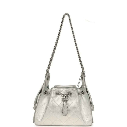 Metallic silver mini hobo bag with quilted caviar texture, chain strap and side tassel