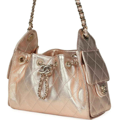 Metallic mini hobo bag with side flap pockets and Chanel CC logo on front, rose-gold shine