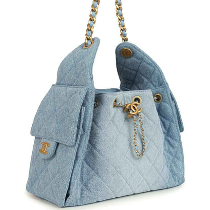 Chanel small hobo bag in light blue denim with quilted front and gold chain drop handles