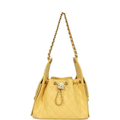 Yellow quilted caviar hobo bag with chain handles and CC tassel charm