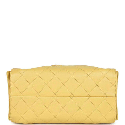 Yellow quilted caviar hobo bag with wide flap closure and gold hardware