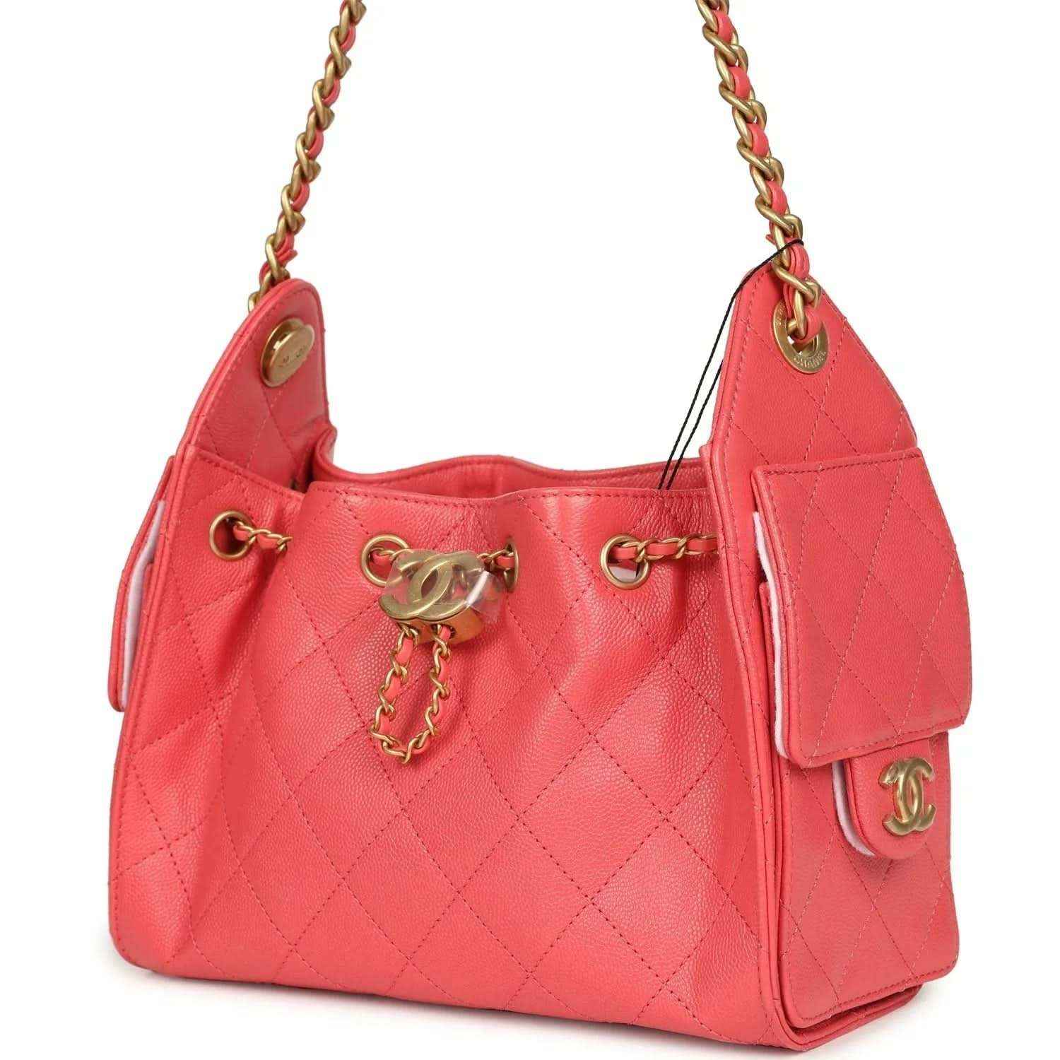 Coral pink quilted mini hobo bag with side tassel detail and gold logo charm