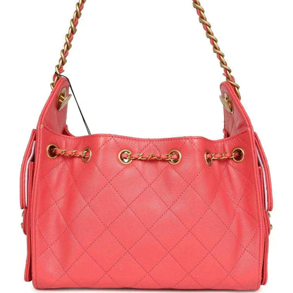 Coral pink quilted mini hobo bag with gold chain handles and open top
