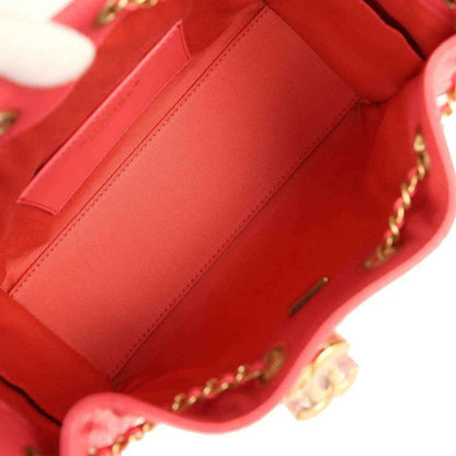 Coral pink leather interior with stitched slip pocket and gold-toned hardware