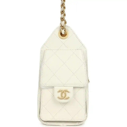 Mini hobo bag back with Chanel logo medallion on white quilted leather and chain ring