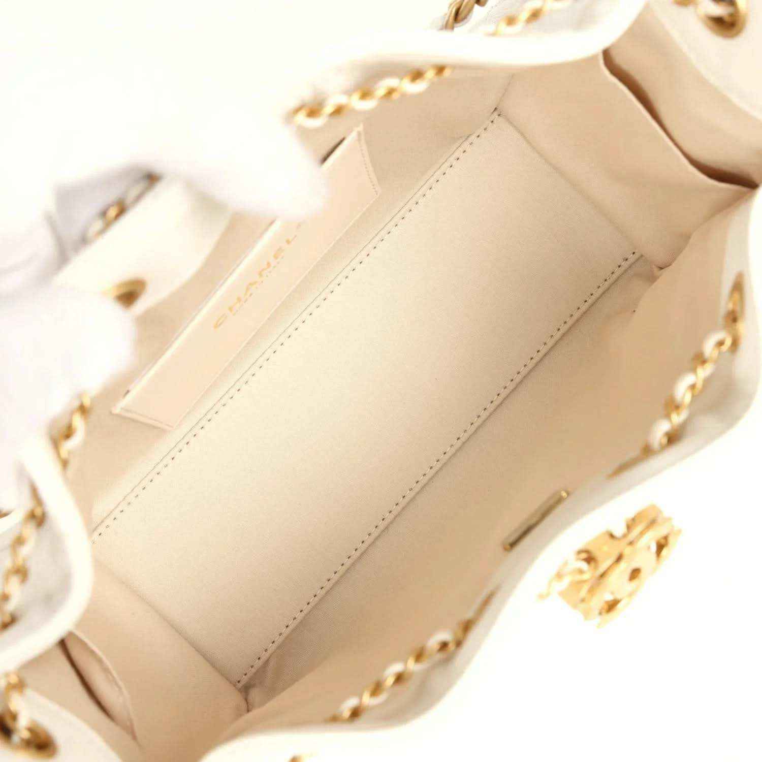 White fabric-lined mini hobo bag interior with stitched panels and gold-tone hardware