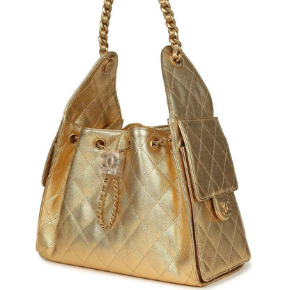 Metallic gold quilted hobo bag with chain straps and side pocket details