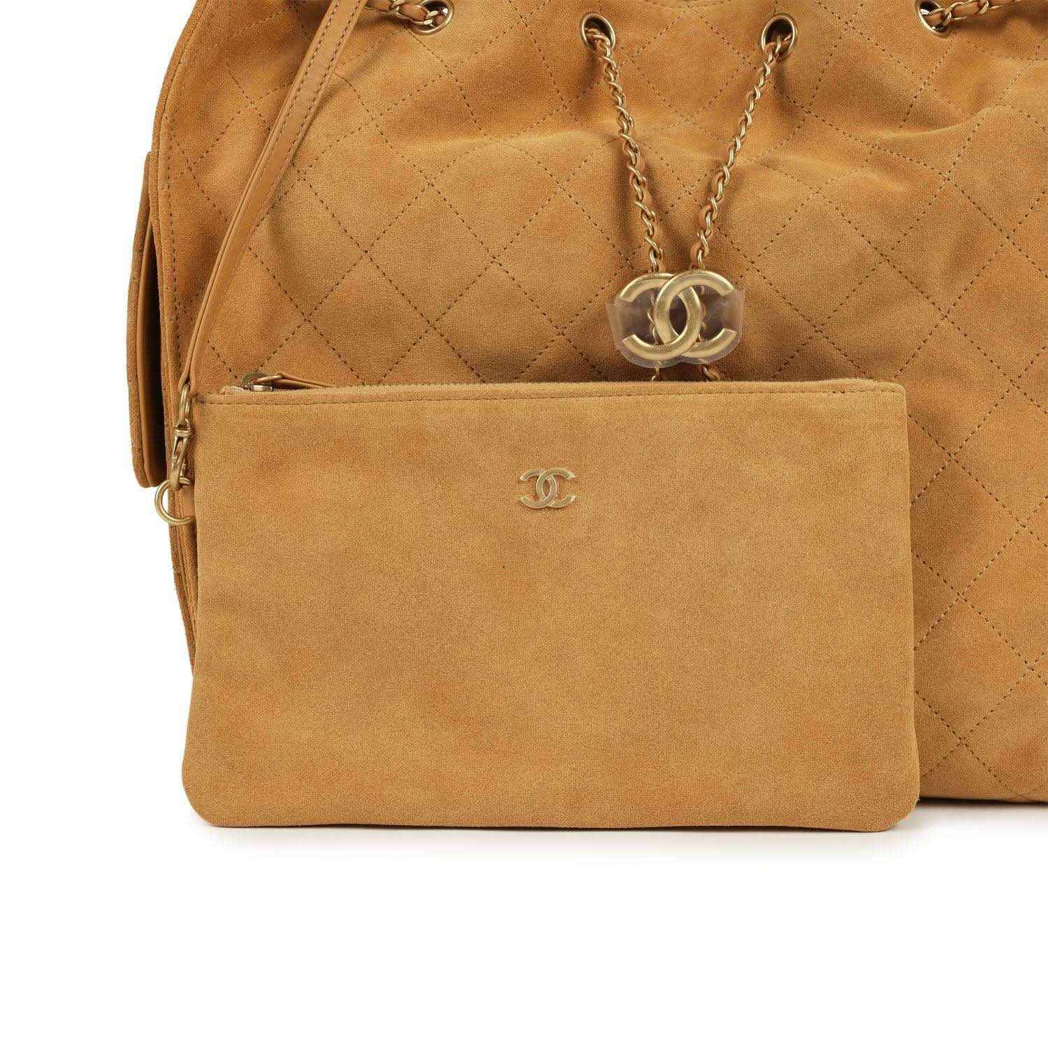 Suede hobo bag detail: front pocket with Chanel logo and chain drop