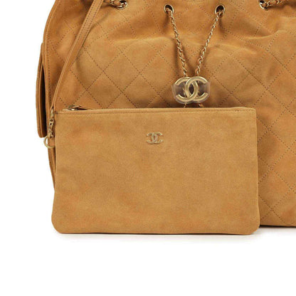 Suede hobo bag detail: front pocket with Chanel logo and chain drop