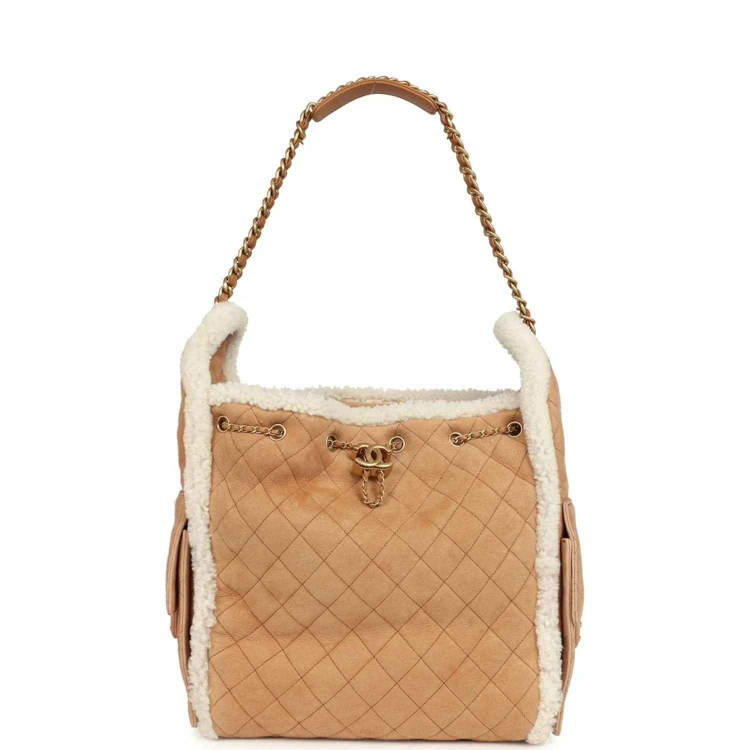 Beige quilted suede hobo bag with white shearling trim, gold chain handle and side tassels