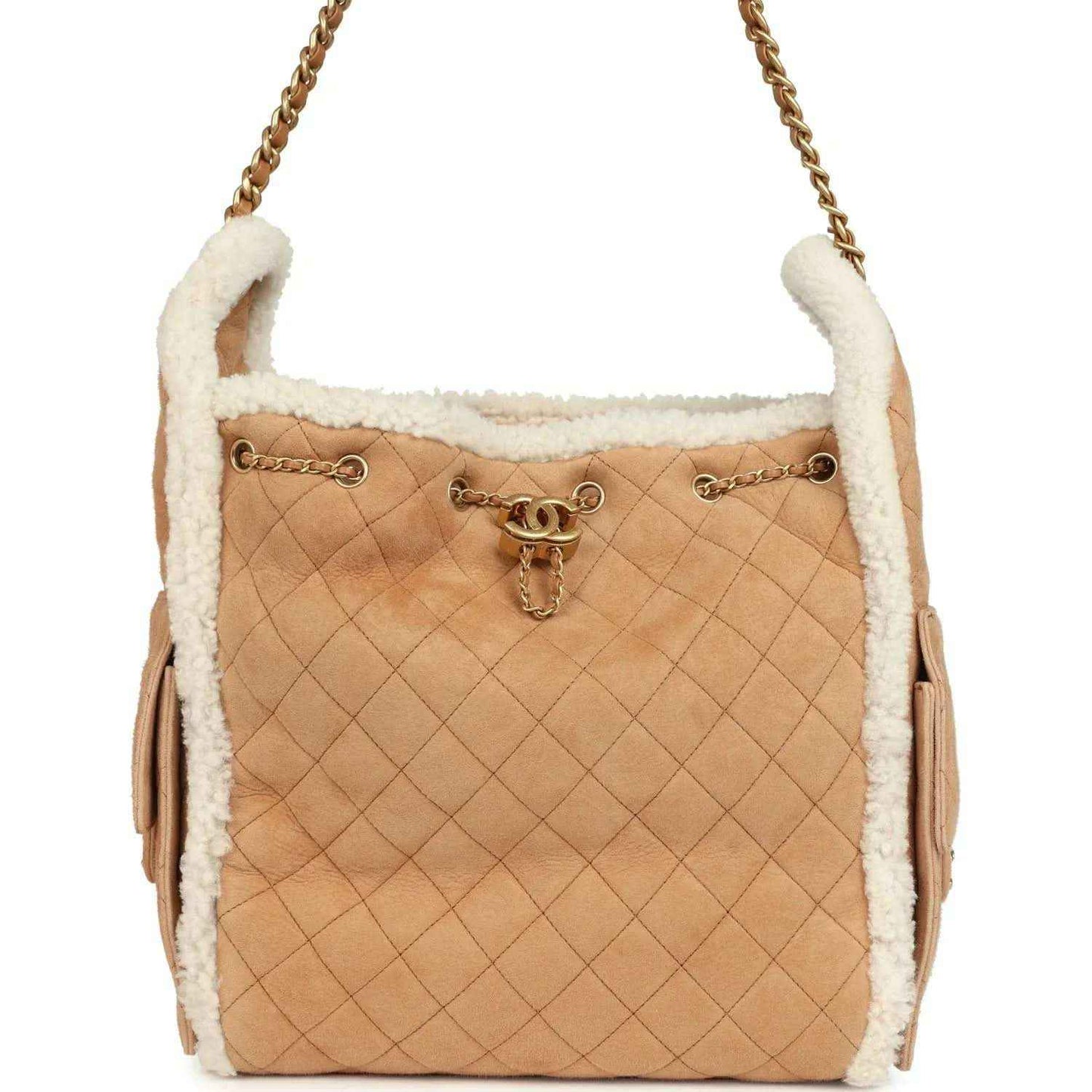 Beige suede hobo bag with white shearling trim and quilted pattern, gold chain handle