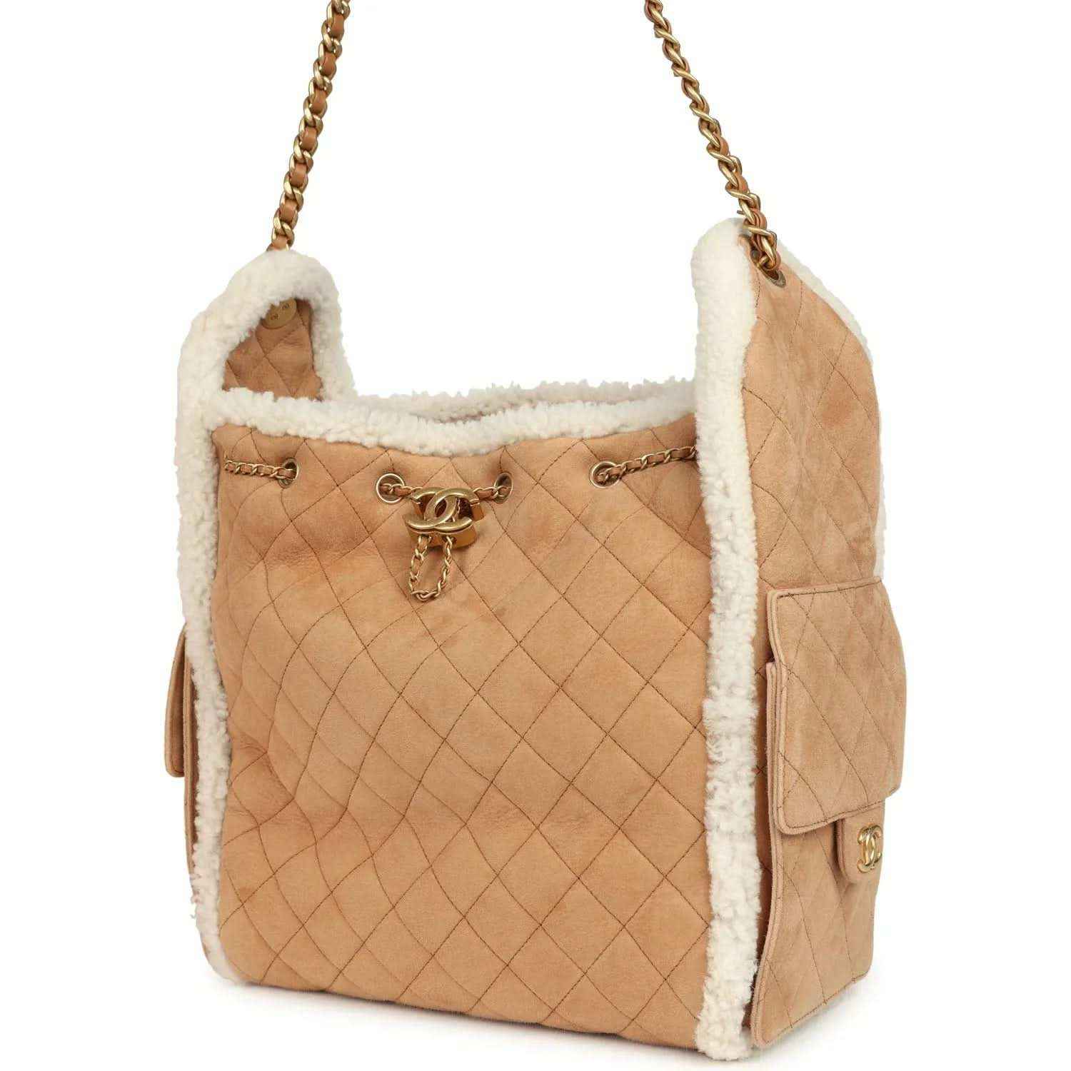 Beige quilted hobo bag with white shearling trim, gold chain strap and side flap pocket