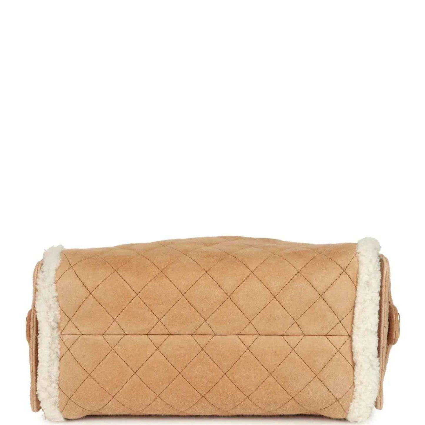 Beige suede hobo bag with quilted front and white shearling trim along the top edge