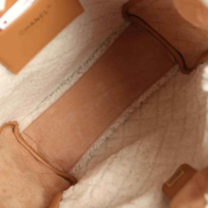Beige suede hobo bag open interior with leather slip pocket and soft white lining