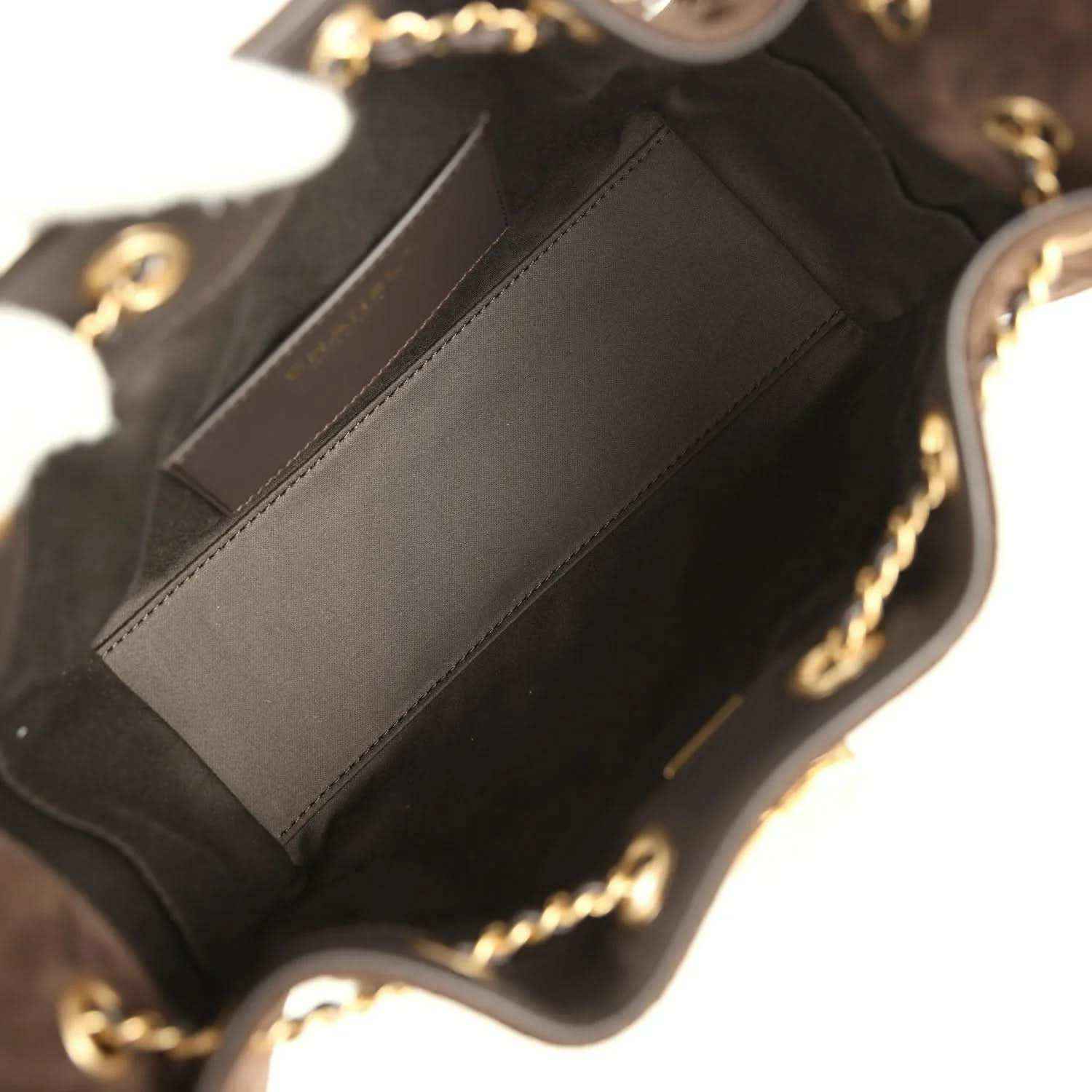 Dark brown suede mini hobo bag interior with stitched pocket panel and gold-tone chain hardware.