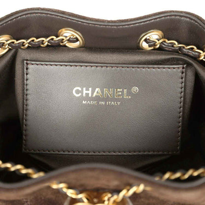 Mini hobo bag interior label reading CHANEL and Made in Italy on gray lining.
