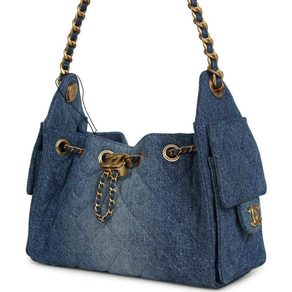 Blue washed denim mini hobo bag with chain strap, front drawcord detail, and side tassel