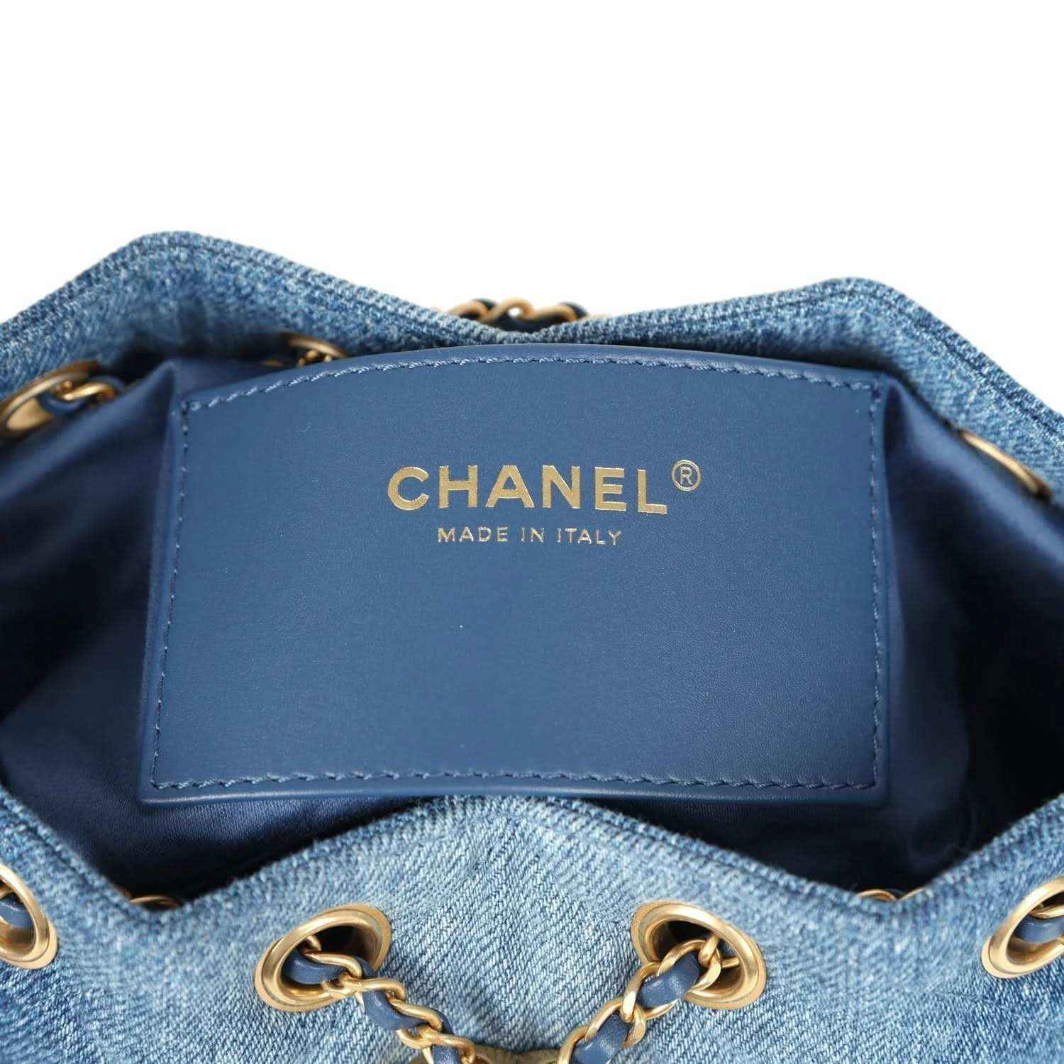 Chanel interior label on blue denim mini hobo bag lining, with gold chain hardware at sides