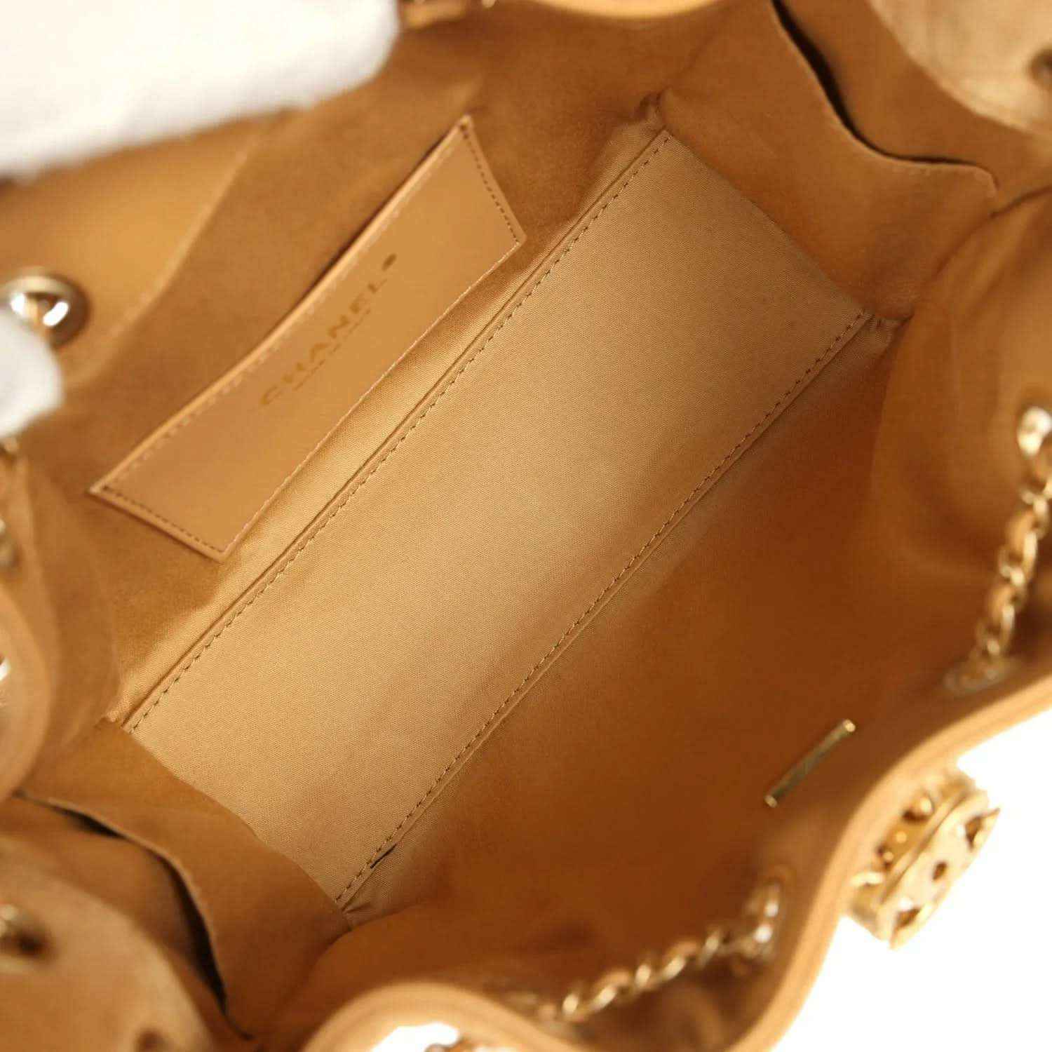 Tan suede hobo bag interior with two slip pockets and visible stitching near lining