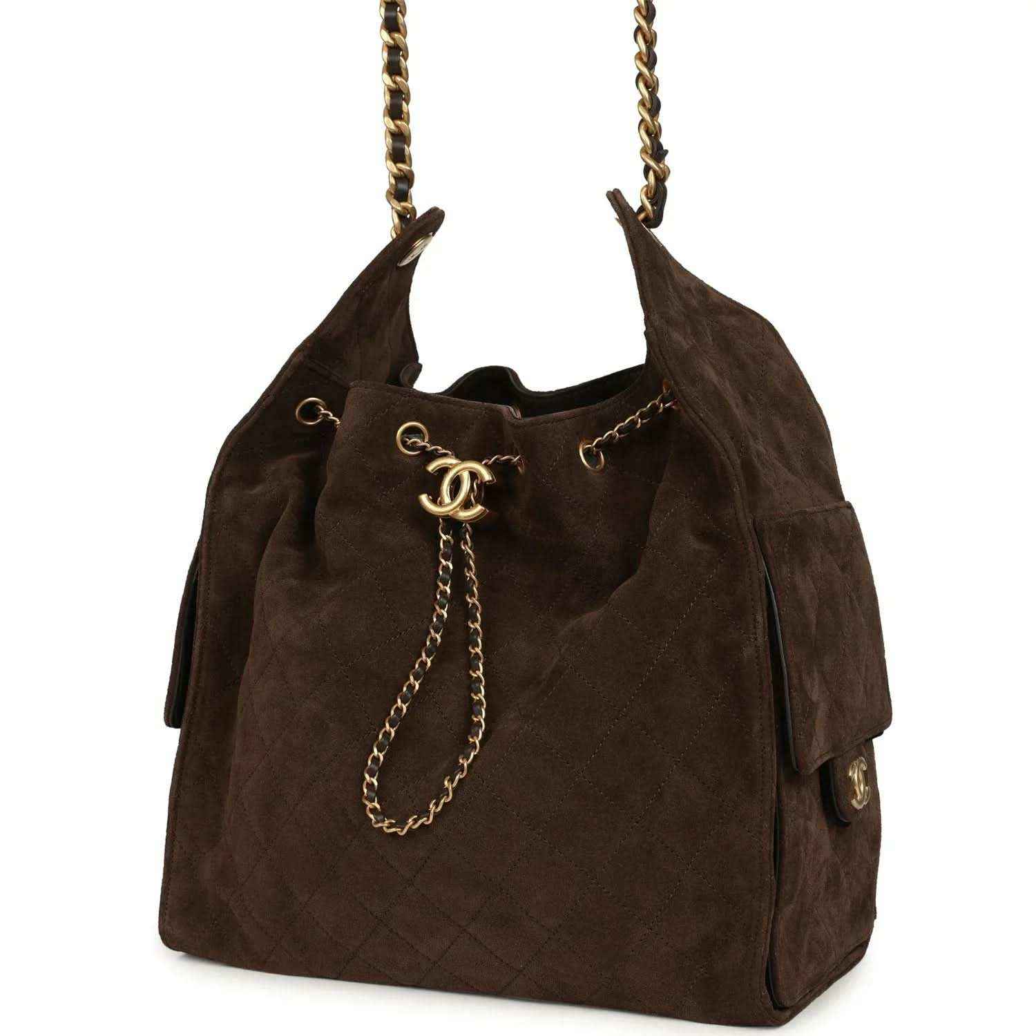 Dark brown suede hobo bag with chain handles and gold CC logo center charm