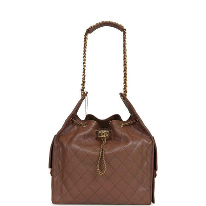 Brown quilted hobo bag with gold-tone chain handles and Chanel turn-lock clasp
