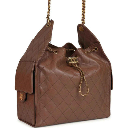 Brown quilted hobo bag with gold-tone chain strap and Chanel turn-lock clasp