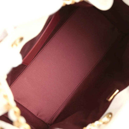 Chanel small hobo bag interior with burgundy fabric lining and gold chain edge