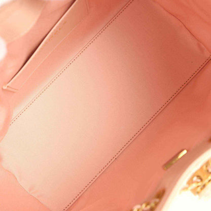 Light pink bag lining interior with stitched panel and gold-toned hardware