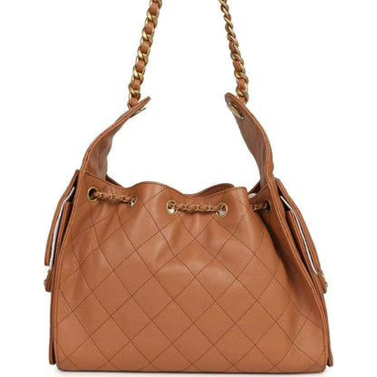 Brown quilted leather hobo bag with gold chain handles and side fringe pulls