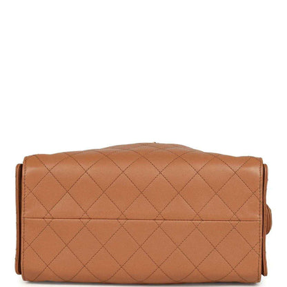 Brown quilted leather shoulder bag with flap closure and gold-toned trim
