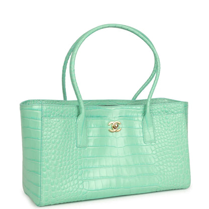 Teal croc-embossed leather shopping tote with front pocket and gold Chanel logo