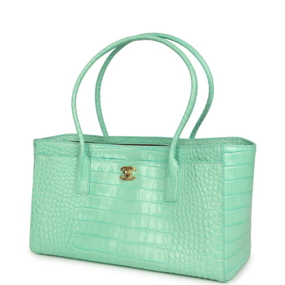 Teal croc-embossed leather tote bag with front strap pocket and two handles
