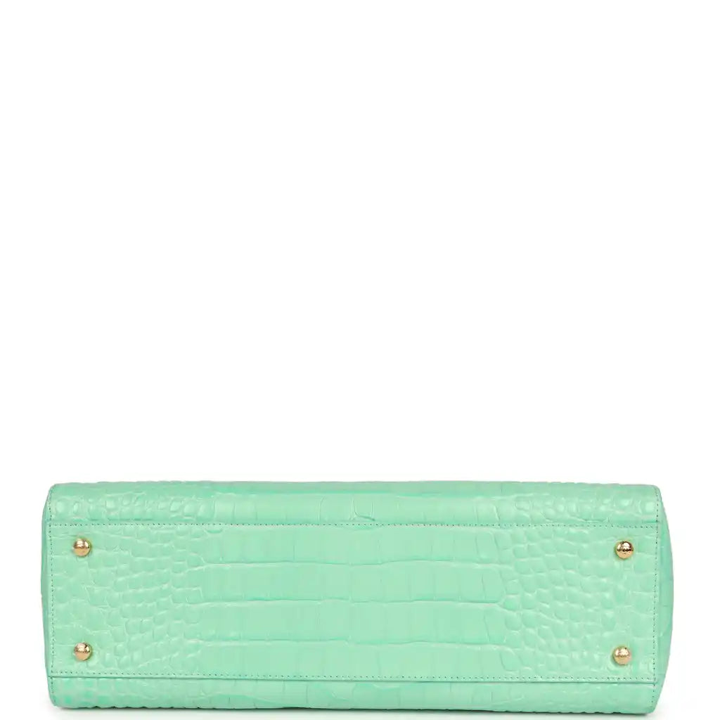 Teal croc-embossed leather rectangular bag with two rear feet grommets