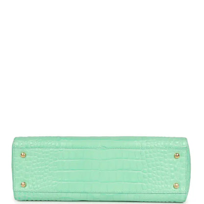 Teal croc-embossed leather rectangular bag with two rear feet grommets
