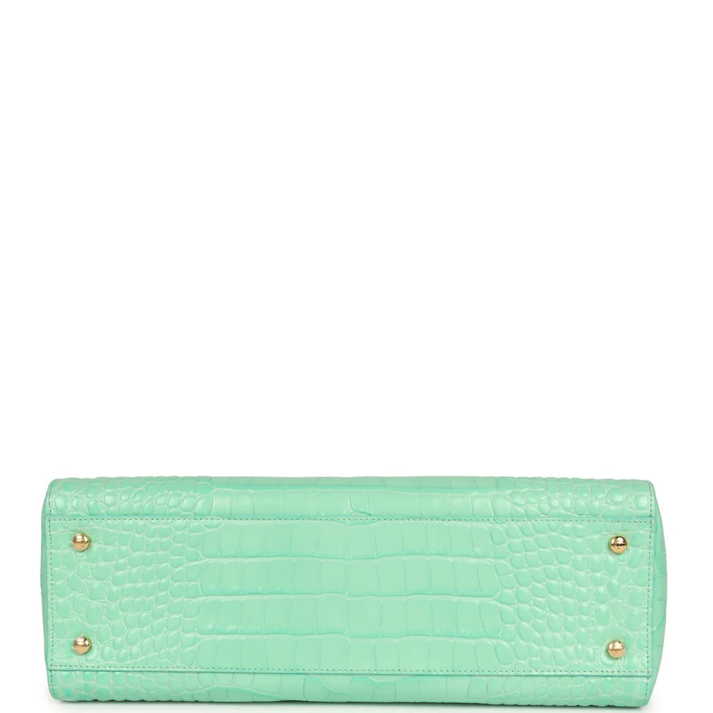 Teal croc-embossed leather rectangular bag with two rear feet grommets