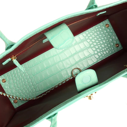 Teal croc-embossed leather interior with chain strap, pocket, and burgundy lining