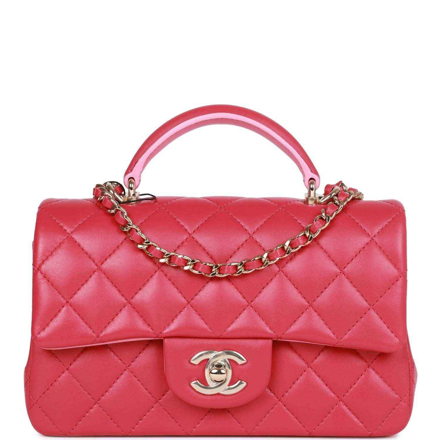 Pink quilted mini flap bag with top handle, chain strap, Chanel turn-lock clasp.
