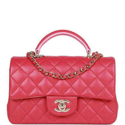 Pink quilted mini flap bag with top handle, chain strap, Chanel turn-lock clasp.
