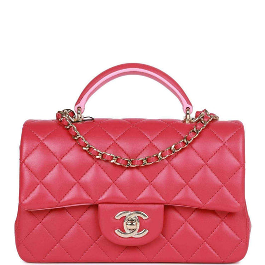 Pink quilted mini flap bag with top handle, chain strap, Chanel turn-lock clasp.