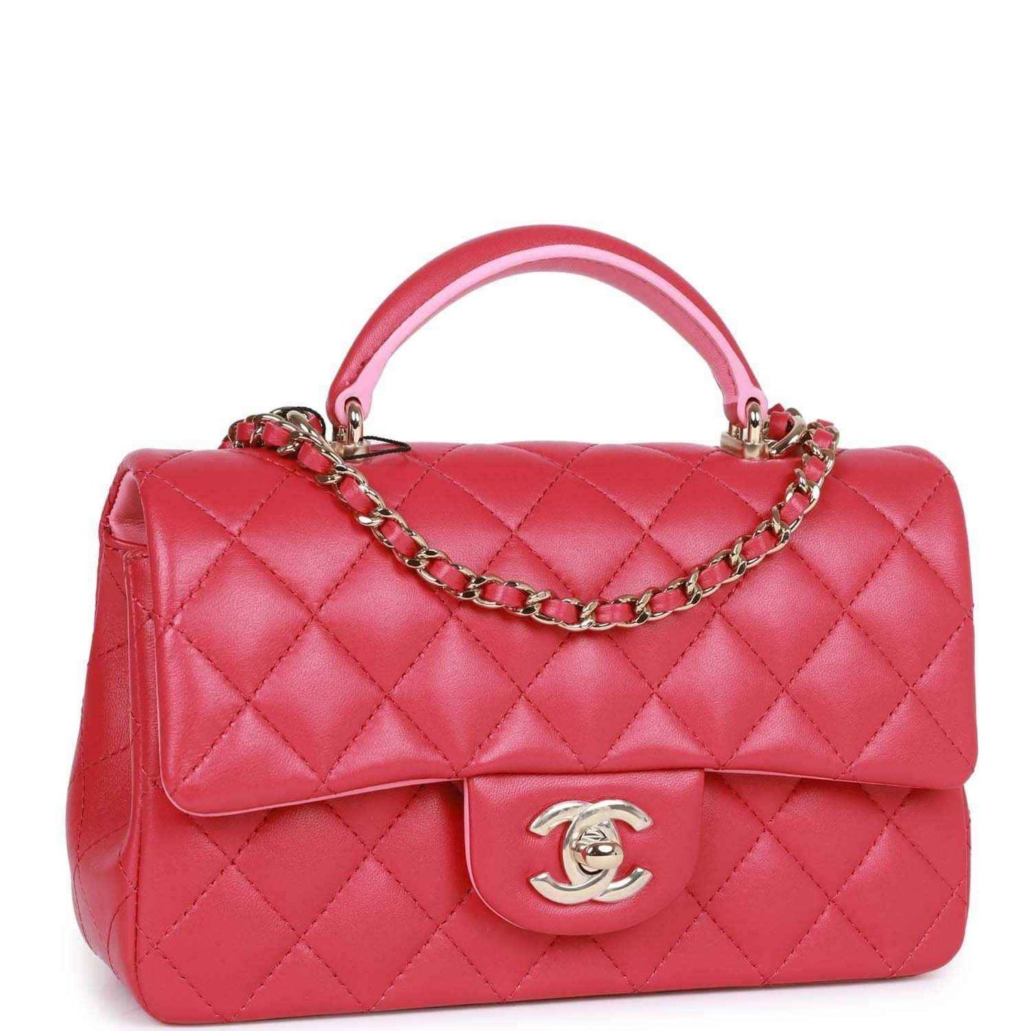 Pink quilted mini flap bag with top handle and chain strap, front Chanel medallion.
