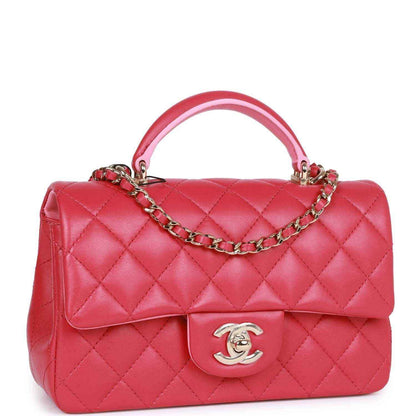 Pink quilted mini flap bag with top handle and chain strap, front Chanel medallion.
