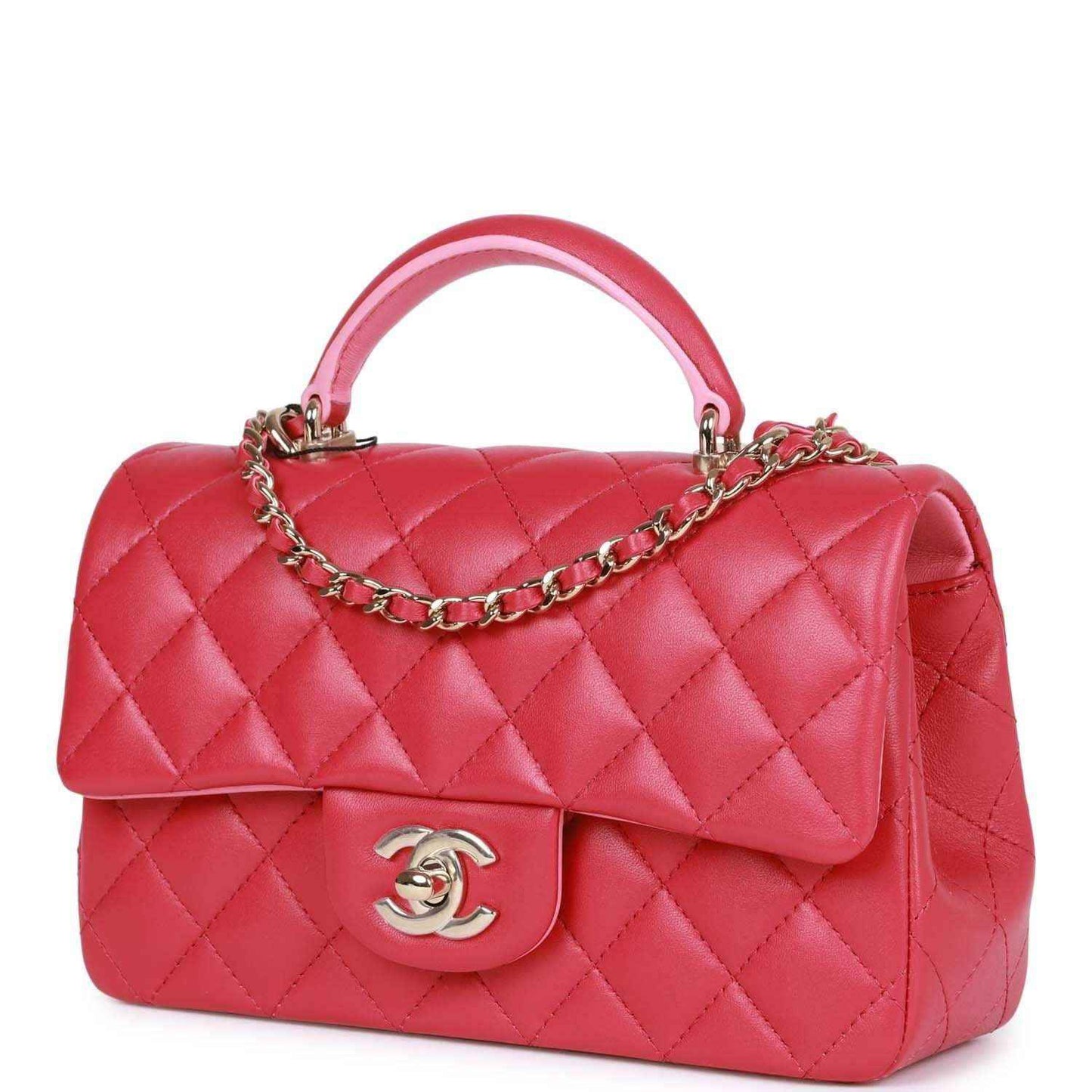 Pink quilted mini flap bag with top handle and chain strap, front Chanel logo.