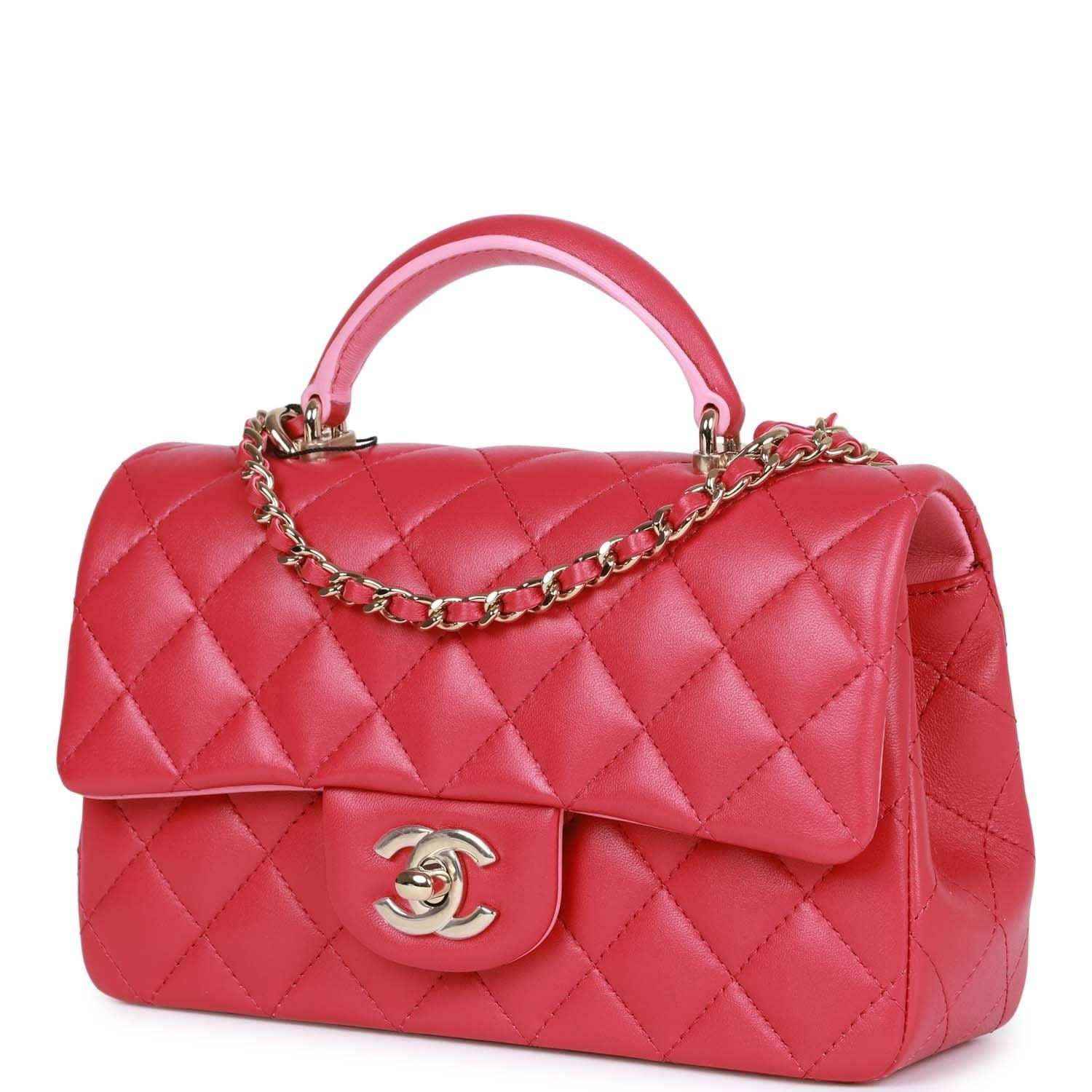 Pink quilted mini flap bag with top handle and chain strap, front Chanel logo.