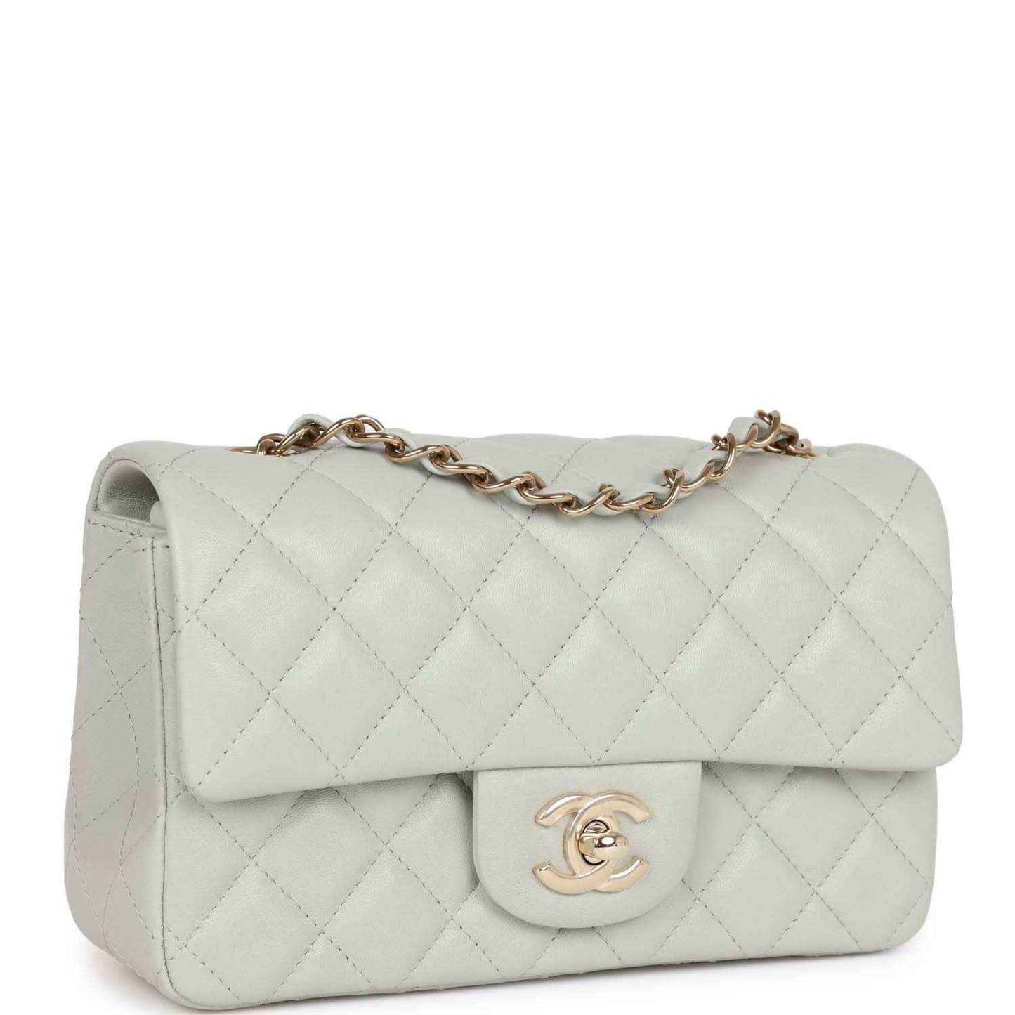 Light grey quilted mini flap bag with front logo emblem and gold-tone chain