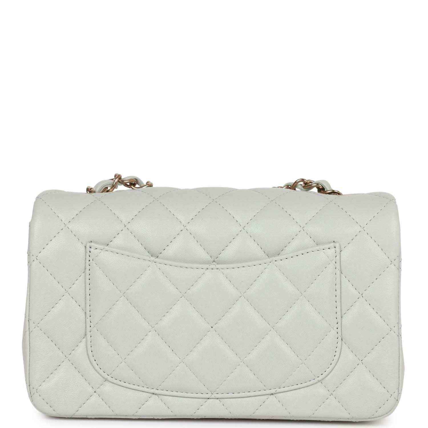 Light grey quilted mini flap bag back view with stitched pocket panel